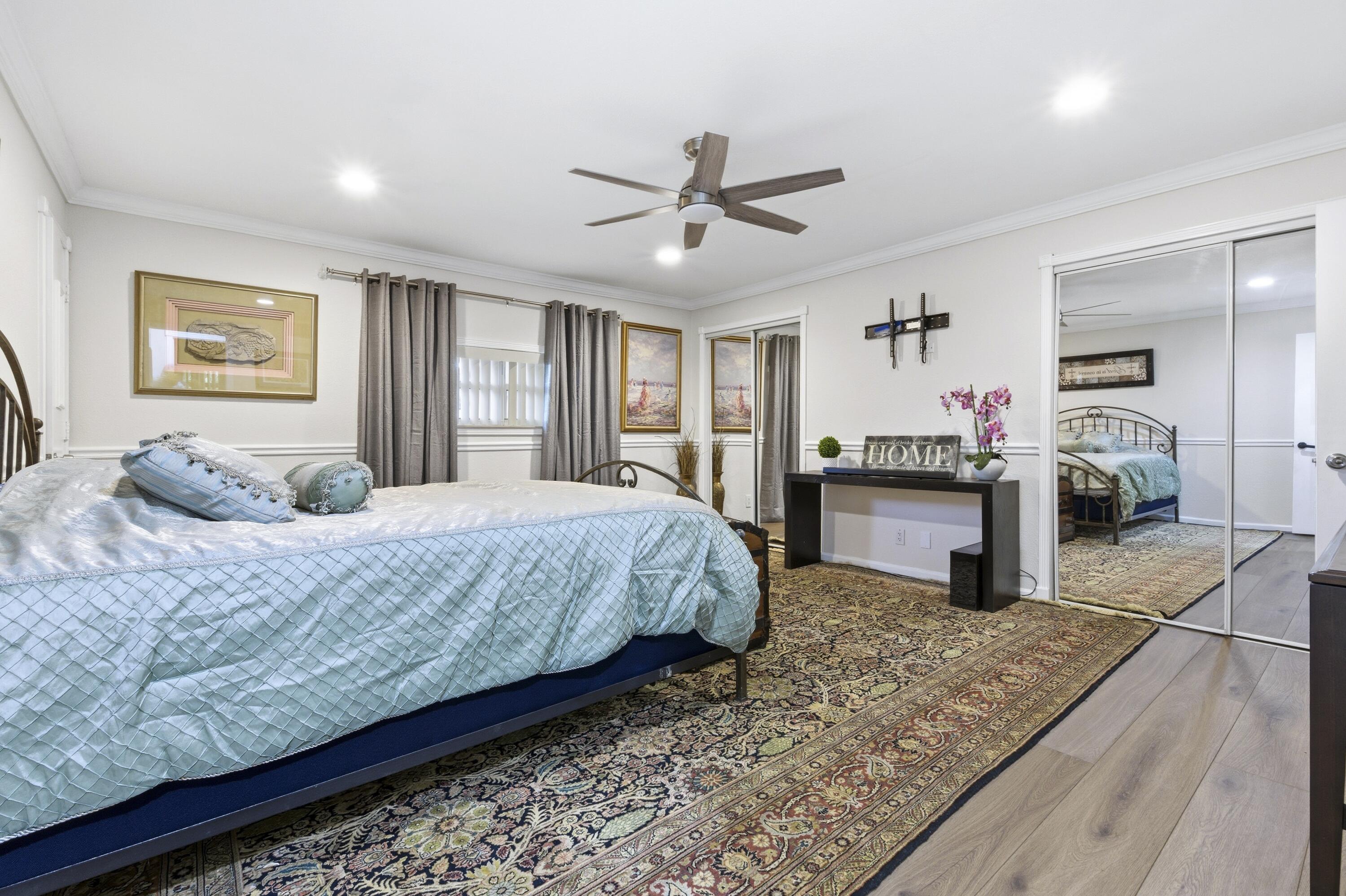1945 Northwest 4th Avenue, Unit 43C Boca Raton, FL 33432 - Photo 16 of 23 a bedroom with a large bed and a flat screen tv
