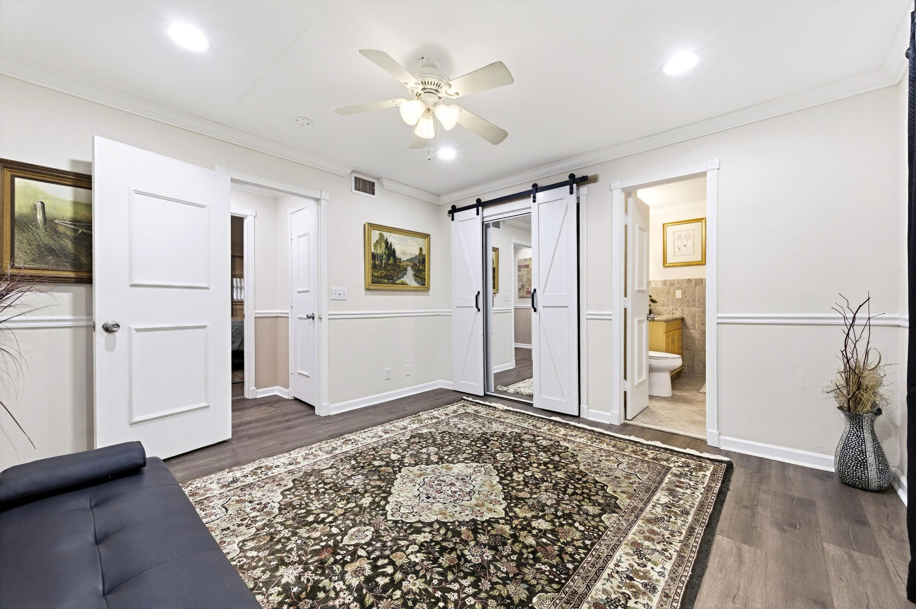 1945 Northwest 4th Avenue, Unit 43C Boca Raton, FL 33432 - Photo 20 of 23 a view of a livingroom with wooden floor and a ceiling fan