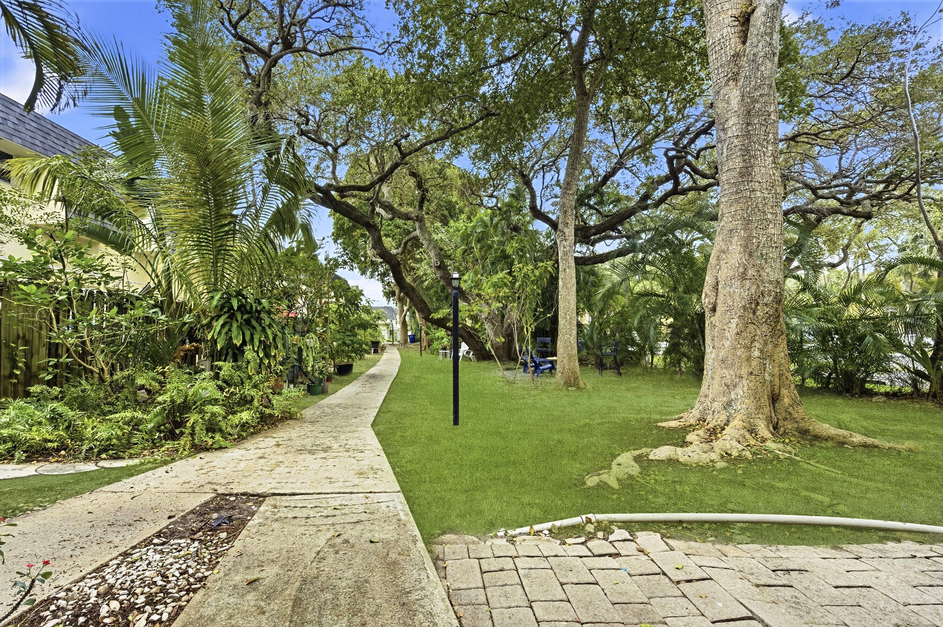 1945 Northwest 4th Avenue, Unit 43C Boca Raton, FL 33432 - Photo 2 of 23 a view of a garden with a bench