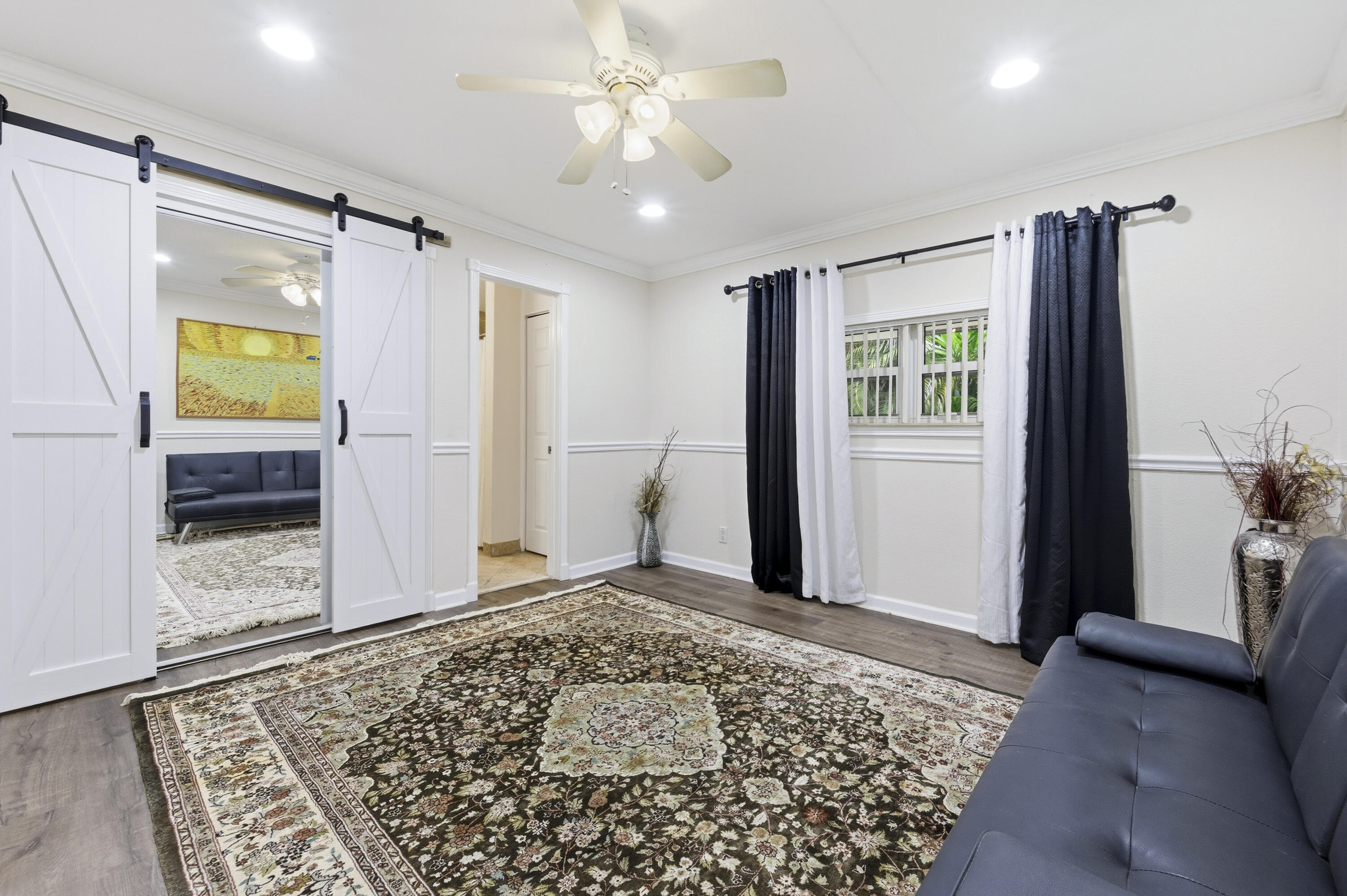 1945 Northwest 4th Avenue, Unit 43C Boca Raton, FL 33432 - Photo 21 of 23 a view of livingroom with a ceiling fan and window