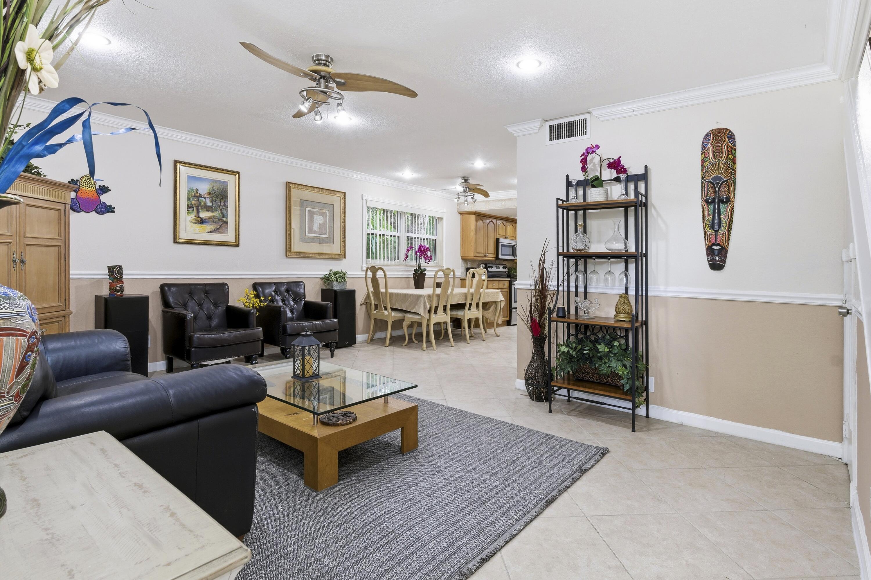 1945 Northwest 4th Avenue, Unit 43C Boca Raton, FL 33432 - Photo 4 of 23 a living room with furniture and wooden floor