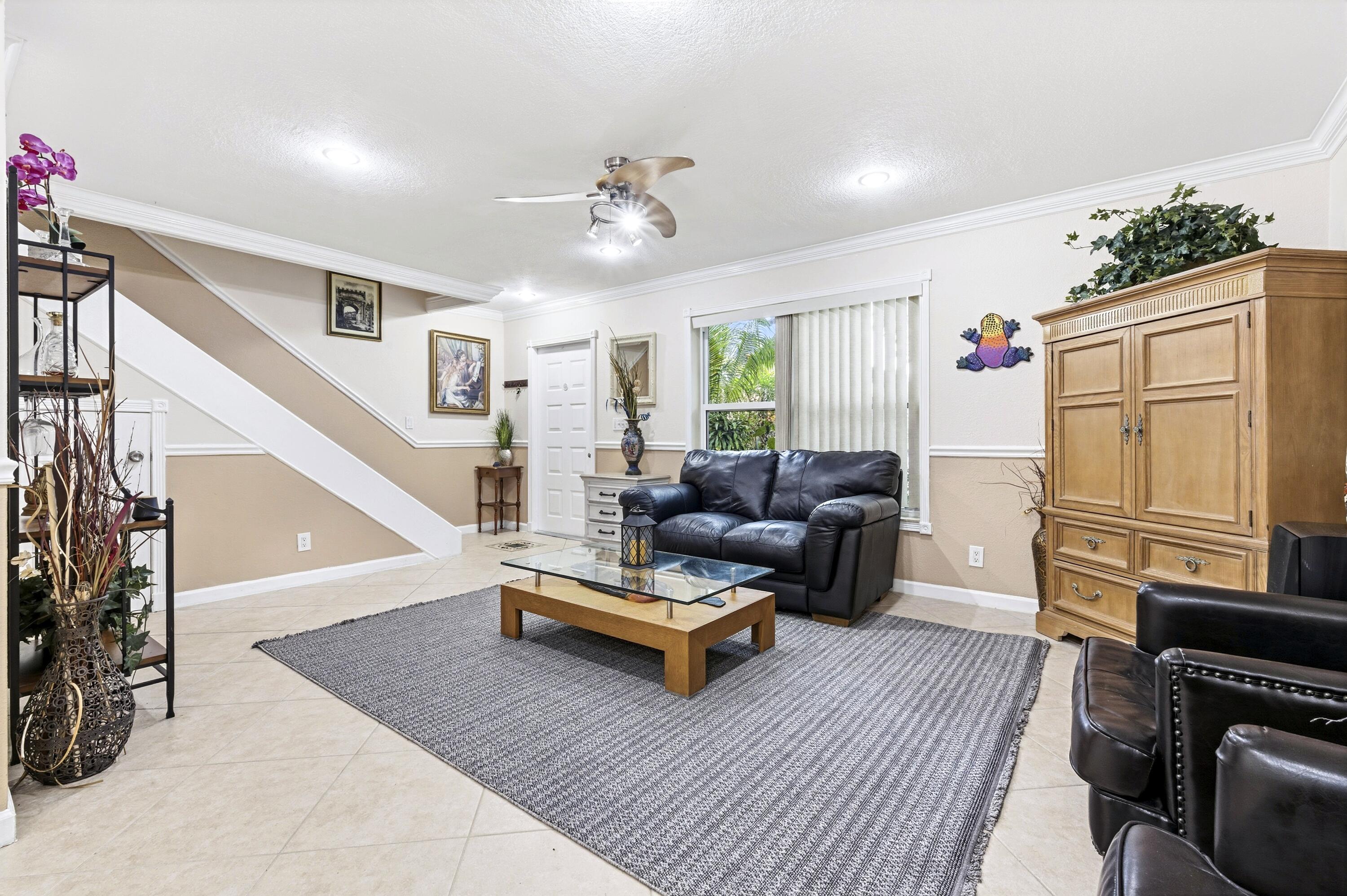 1945 Northwest 4th Avenue, Unit 43C Boca Raton, FL 33432 - Photo 5 of 23 a living room with furniture and a fireplace