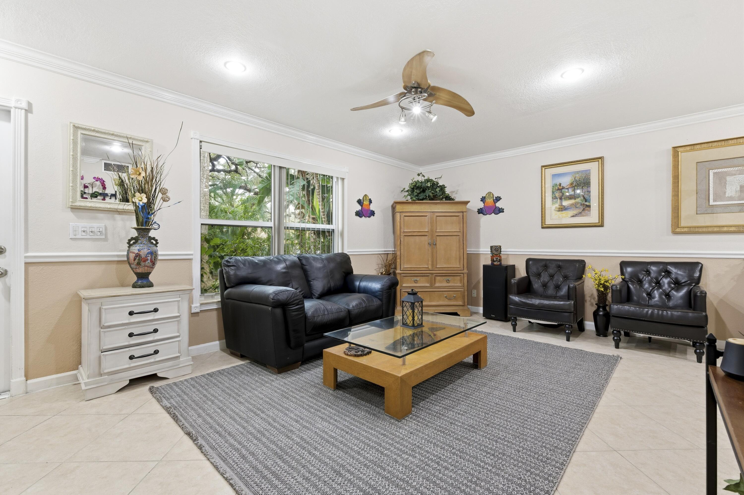 1945 Northwest 4th Avenue, Unit 43C Boca Raton, FL 33432 - Photo 6 of 23 a living room with furniture and a flat screen tv