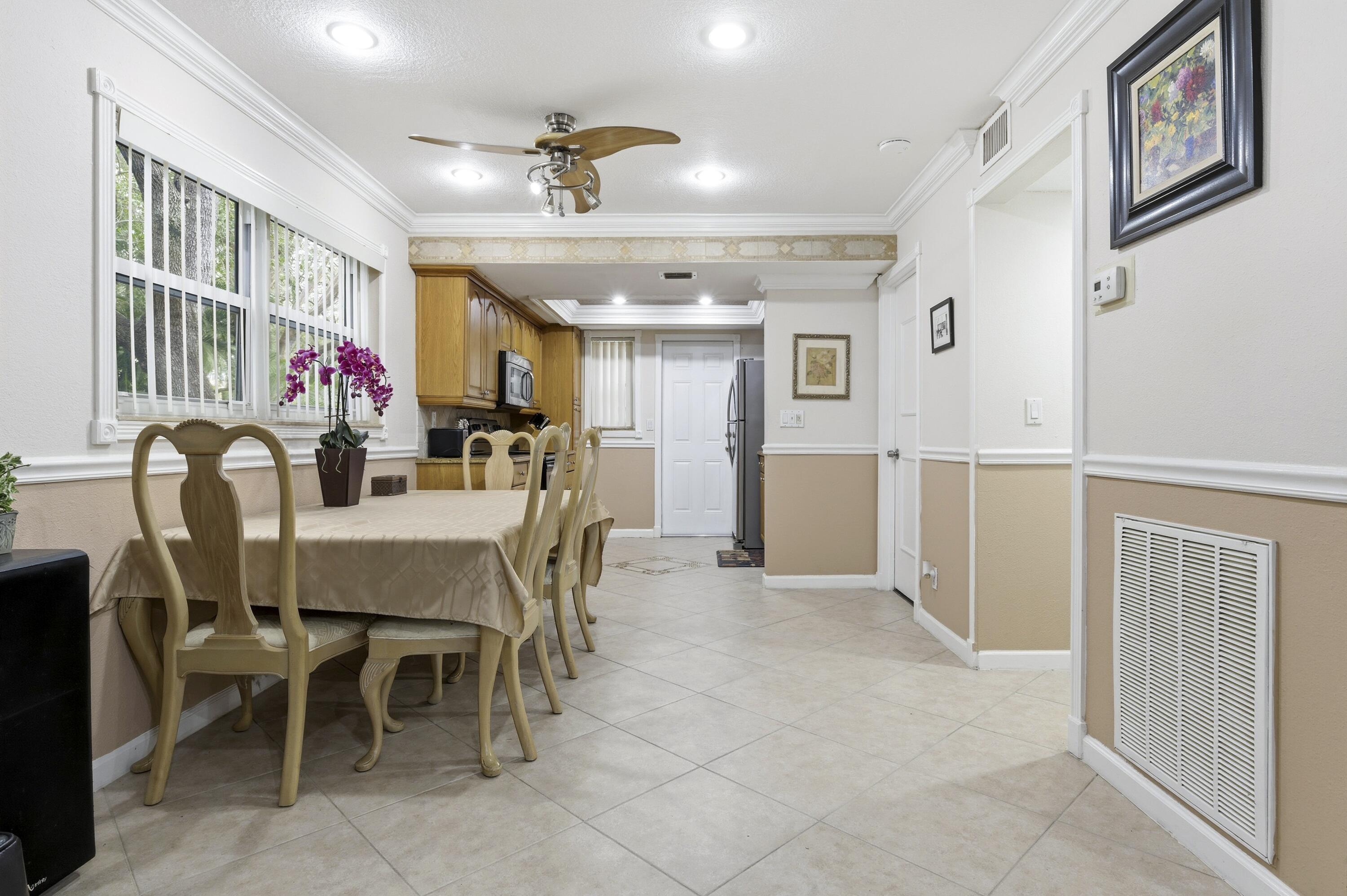 1945 Northwest 4th Avenue, Unit 43C Boca Raton, FL 33432 - Photo 7 of 23 a view of a dining room with furniture