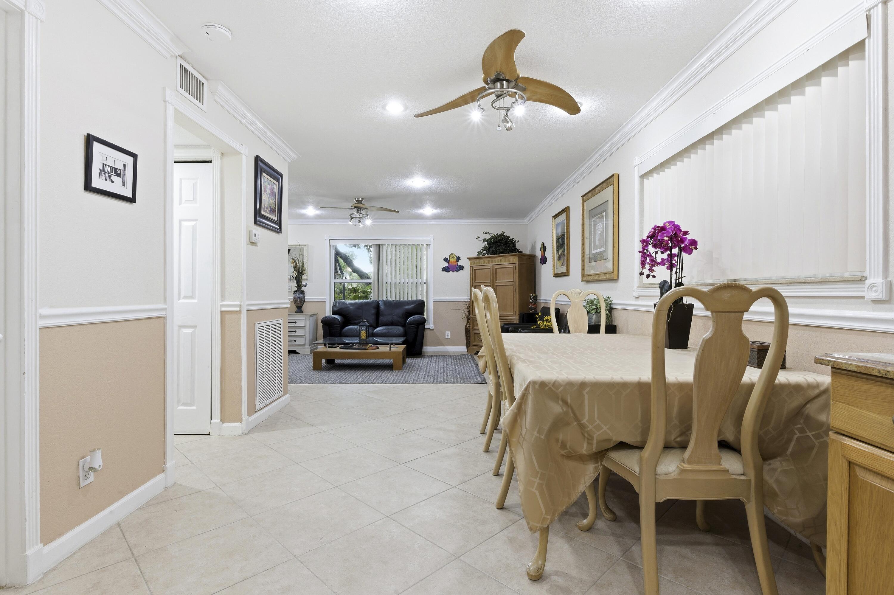 1945 Northwest 4th Avenue, Unit 43C Boca Raton, FL 33432 - Photo 8 of 23 a view of kitchen and dining area with furniture