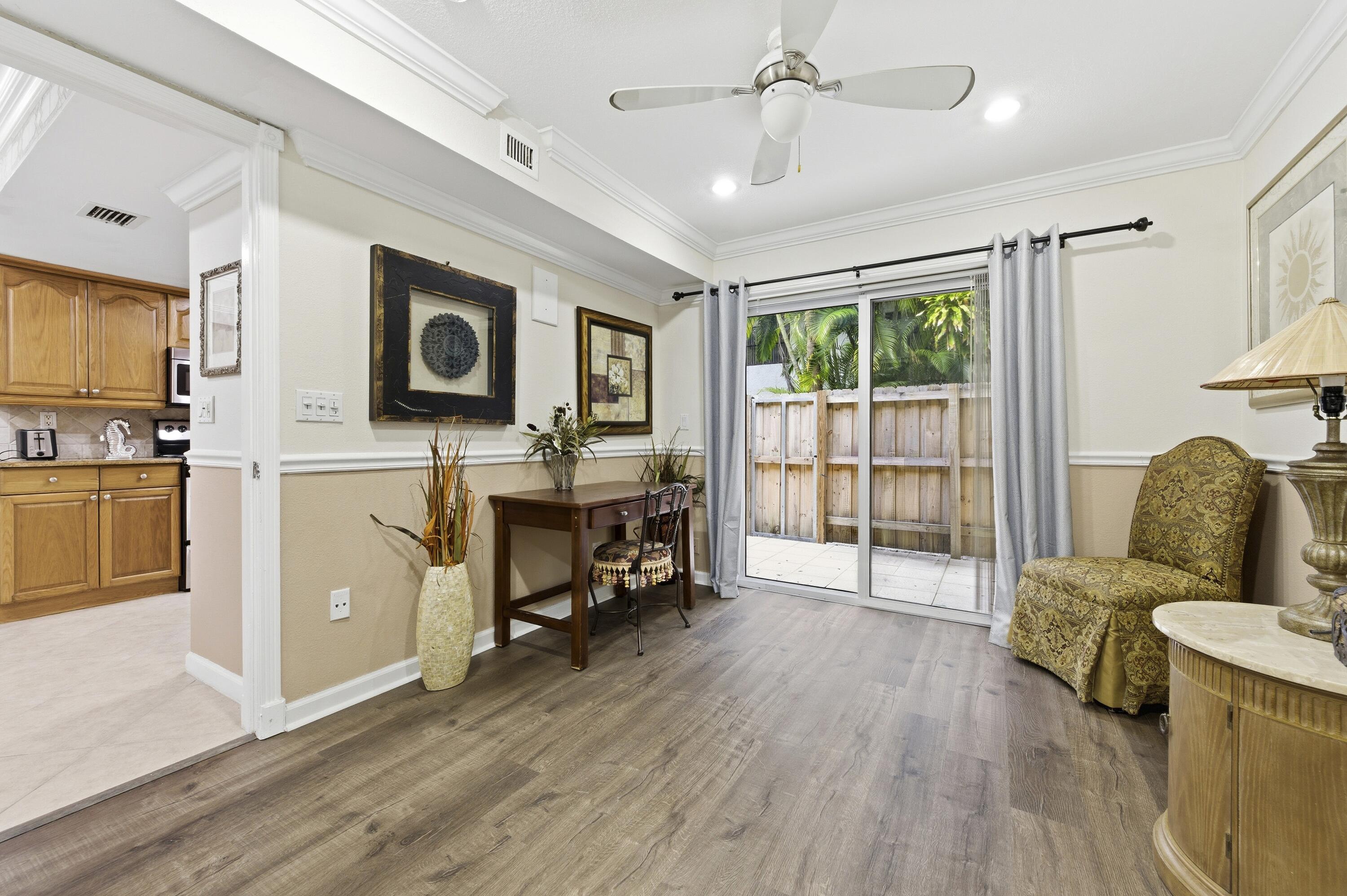 1945 Northwest 4th Avenue, Unit 43C Boca Raton, FL 33432 - Photo 10 of 23 a living room with furniture and a flat screen tv
