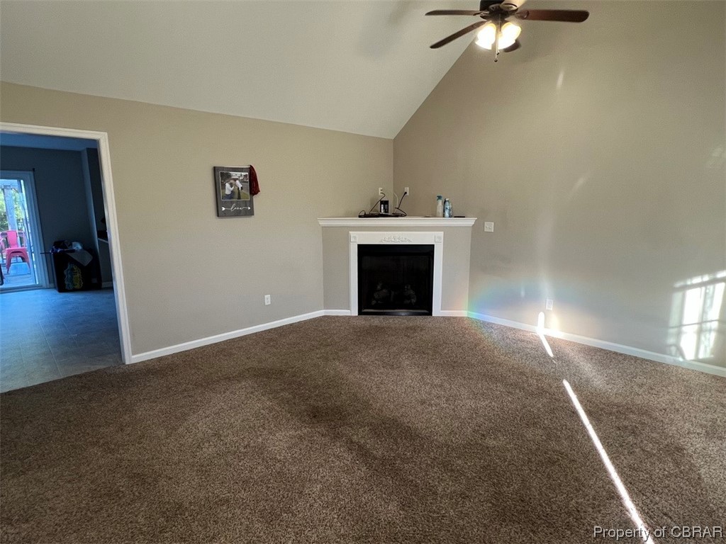 108 Hill Crest Road Wake, VA 23176 - Photo 9 of 21 Unfurnished living room with tile floors, vaulted ceiling high, and ceiling fan
