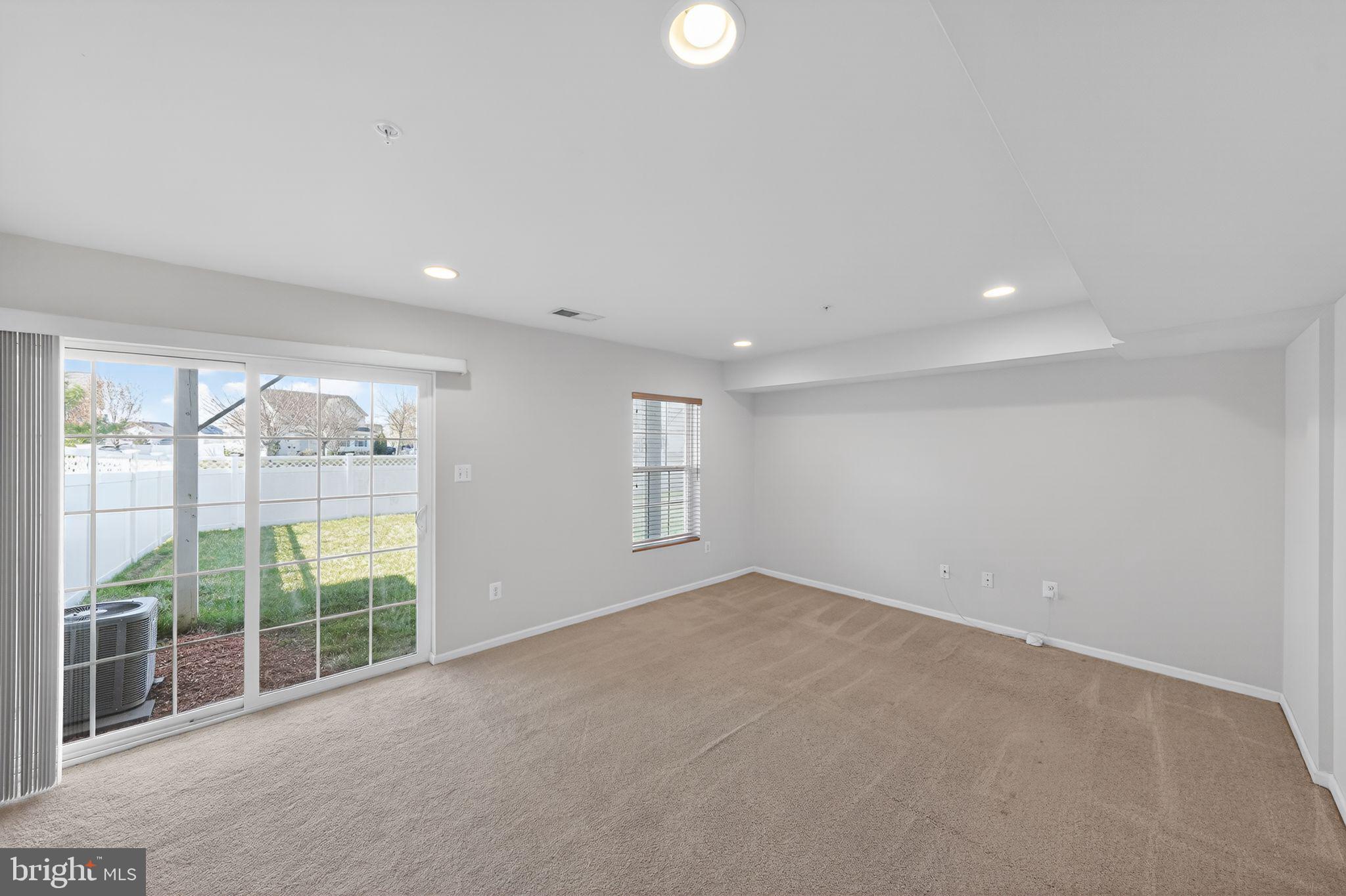 11831 Sunset Ridge Place Waldorf, MD 20602 - Photo 11 of 24 a view of an empty room with wooden floor and windows