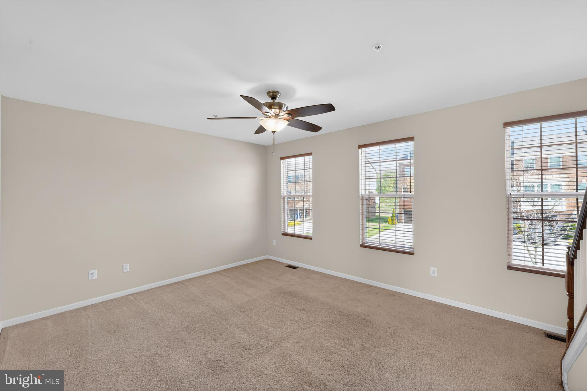 11831 Sunset Ridge Place Waldorf, MD 20602 - Photo 16 of 24 an empty room with windows and ceiling fan