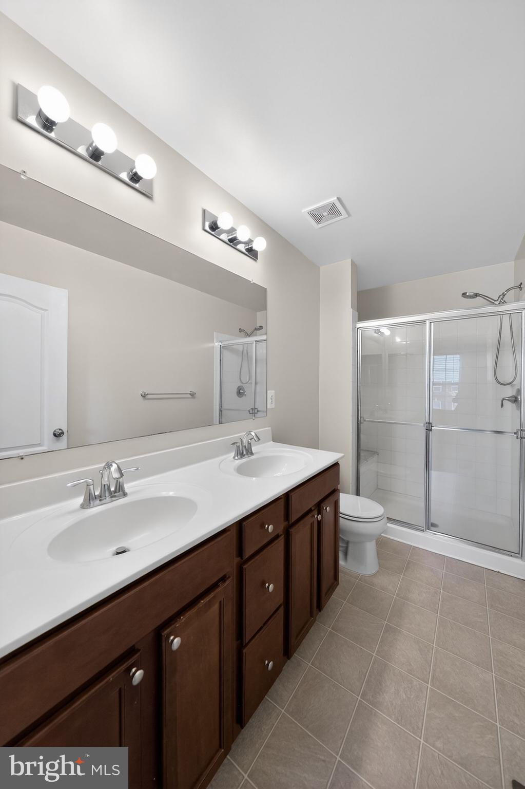 11831 Sunset Ridge Place Waldorf, MD 20602 - Photo 17 of 24 a spacious bathroom with a double vanity sink mirror double and shower