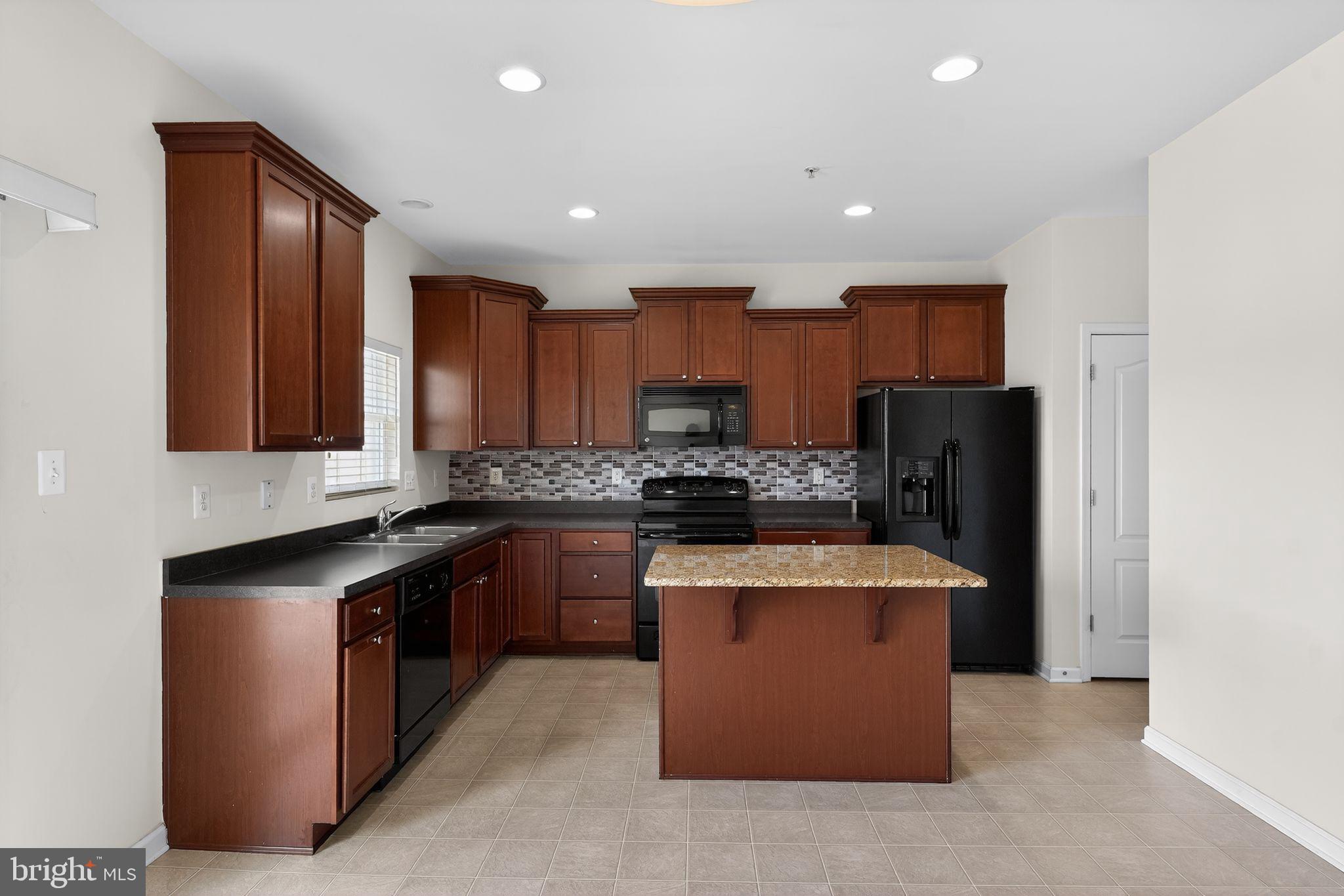 11831 Sunset Ridge Place Waldorf, MD 20602 - Photo 5 of 24 a kitchen with stainless steel appliances granite countertop a refrigerator a sink and a stove