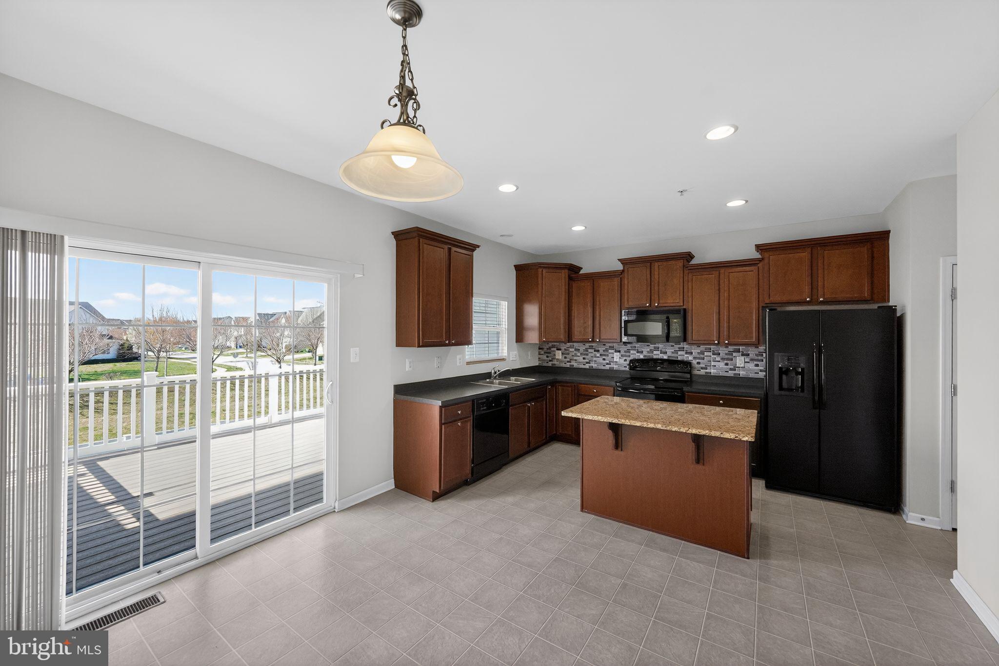 11831 Sunset Ridge Place Waldorf, MD 20602 - Photo 7 of 24 a kitchen with stainless steel appliances granite countertop a refrigerator a sink dishwasher a oven with white cabinets and wooden floor