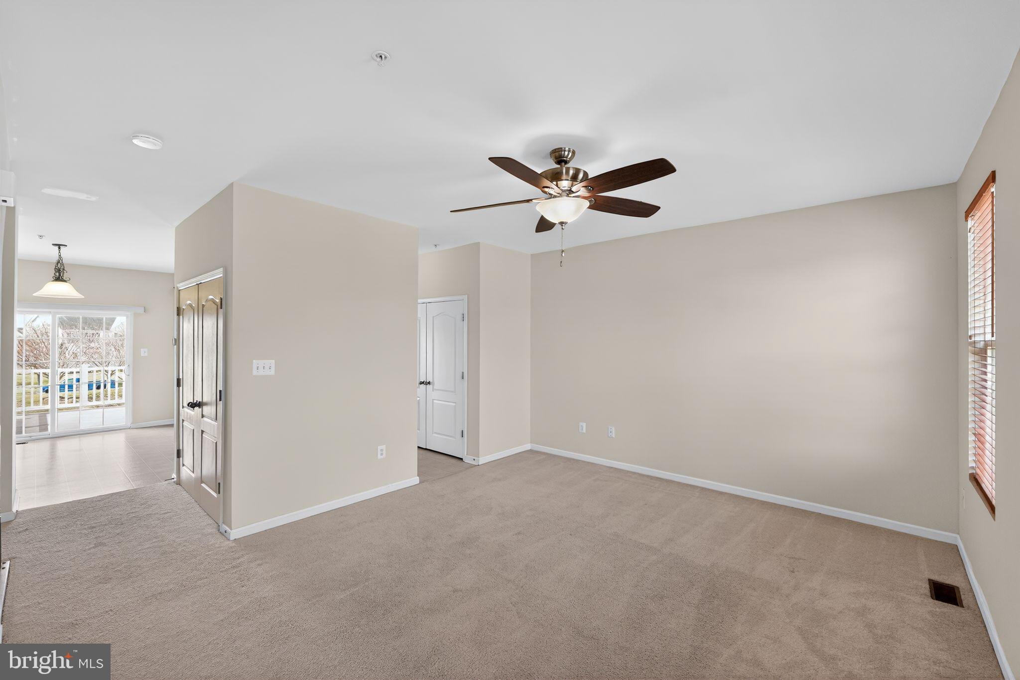 11831 Sunset Ridge Place Waldorf, MD 20602 - Photo 9 of 24 an empty room with a ceiling fan and a window