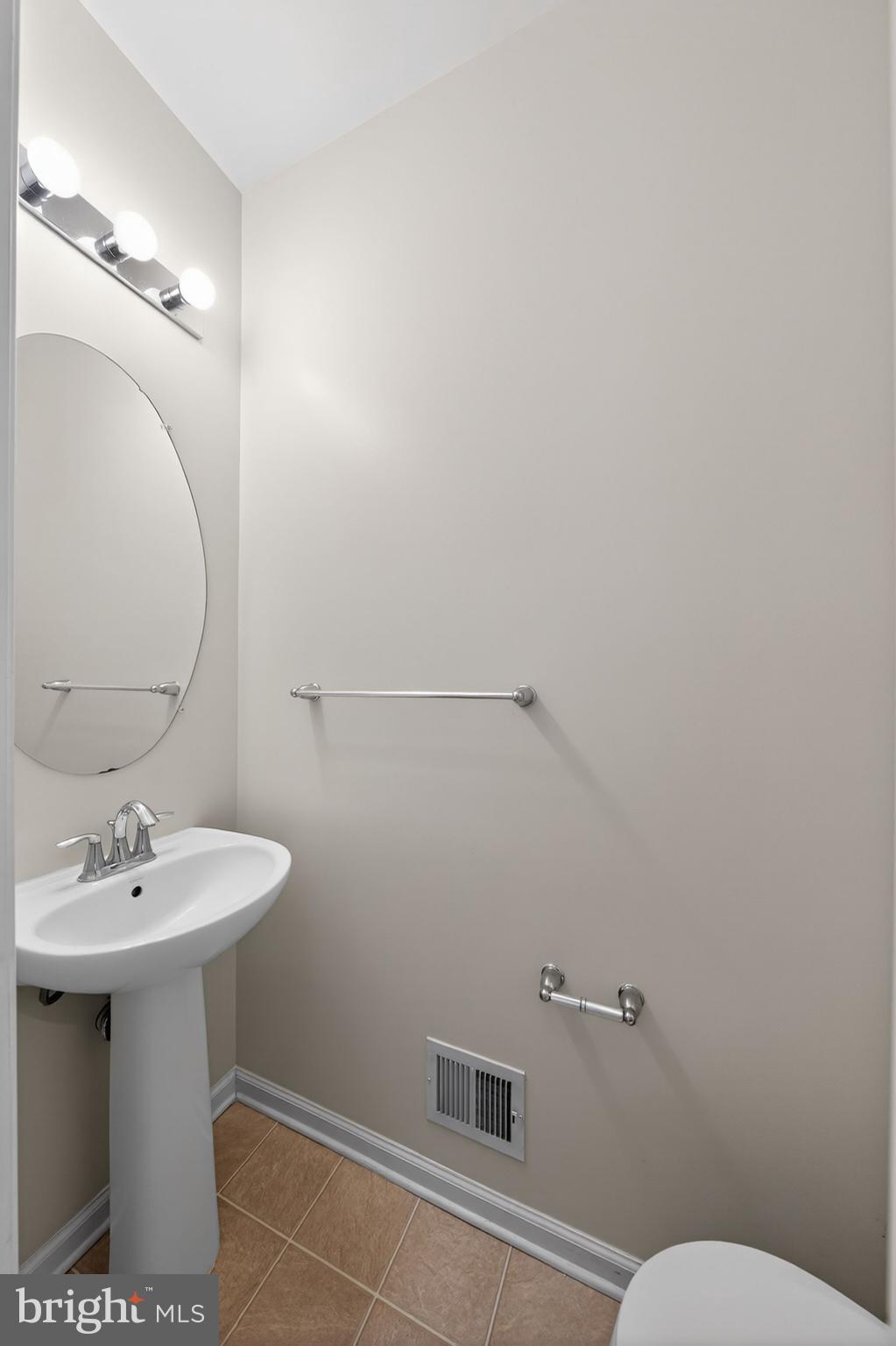 11831 Sunset Ridge Place Waldorf, MD 20602 - Photo 10 of 24 a bathroom with a sink a mirror and a toilet