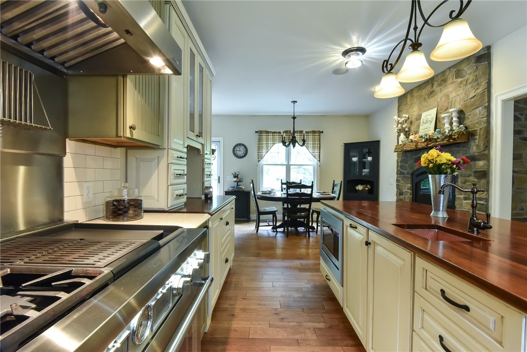 27 Preservation Drive Exeter, RI 02874 - Photo 11 of 41 View of eat in kitchen and gas fireplace