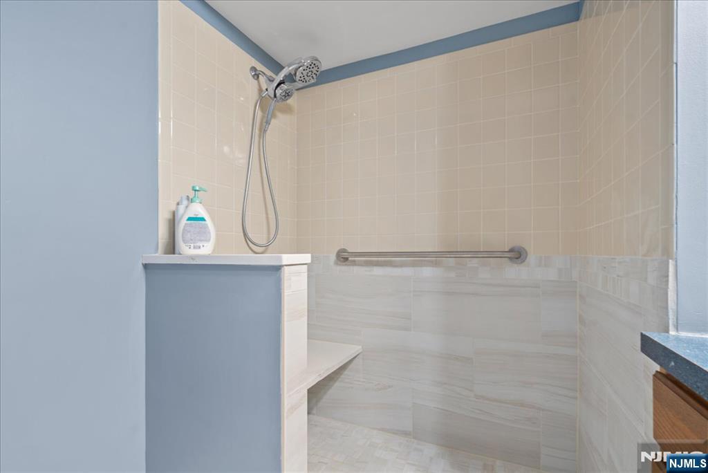 2 Richmond Road, Unit 306 West Milford, NJ 07480 - Photo 12 of 33 a bathroom with a glass shower door
