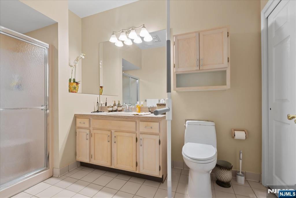 2 Richmond Road, Unit 306 West Milford, NJ 07480 - Photo 13 of 33 a bathroom with a toilet a sink and a mirror