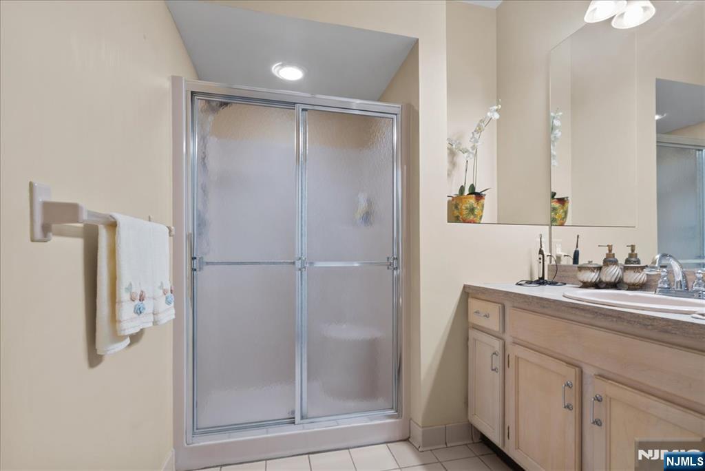 2 Richmond Road, Unit 306 West Milford, NJ 07480 - Photo 14 of 33 a bathroom with a shower sink and mirror