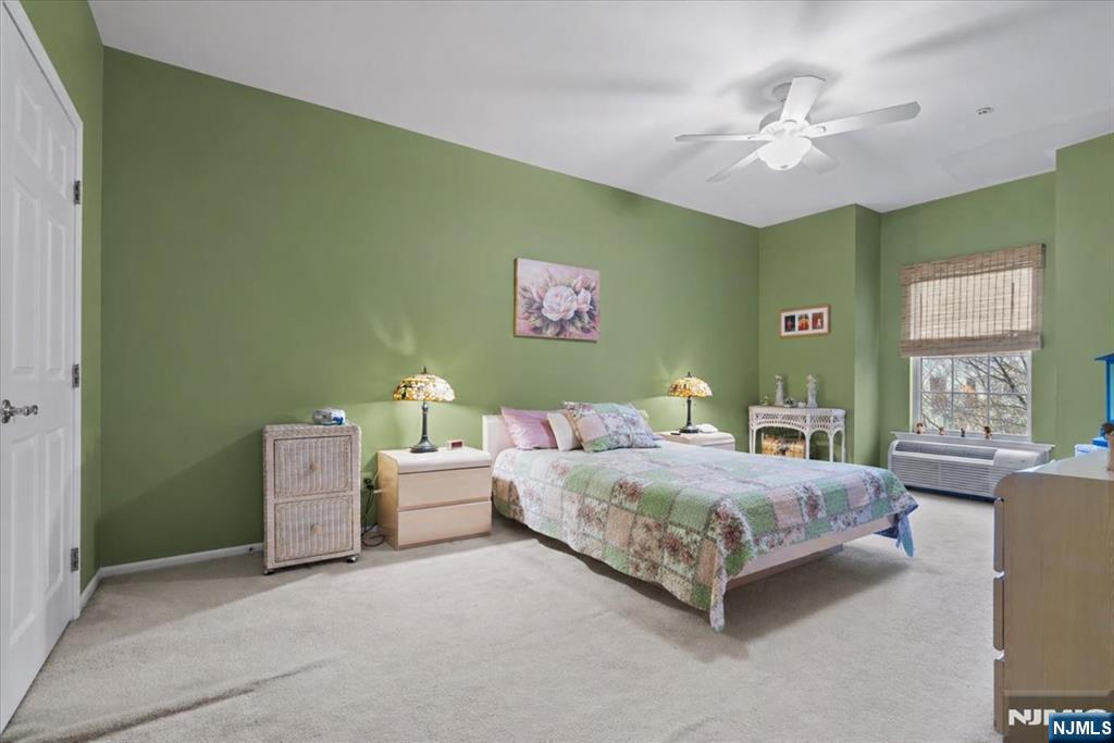 2 Richmond Road, Unit 306 West Milford, NJ 07480 - Photo 15 of 33 a bedroom with a bed and a chandelier