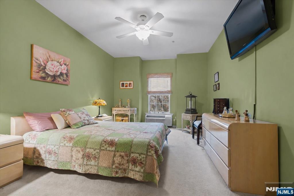 2 Richmond Road, Unit 306 West Milford, NJ 07480 - Photo 16 of 33 a bedroom with a bed and a chandelier