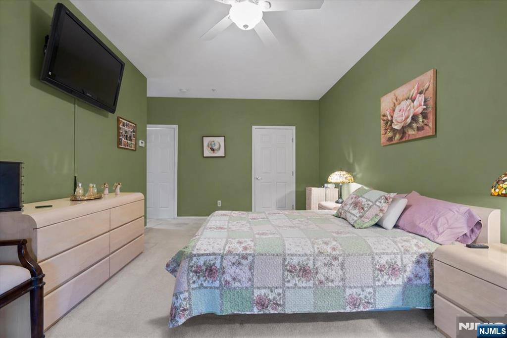 2 Richmond Road, Unit 306 West Milford, NJ 07480 - Photo 17 of 33 a bedroom with a large bed and a flat screen tv