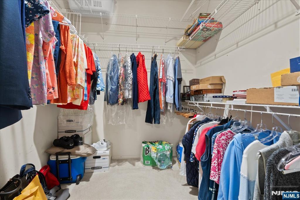 2 Richmond Road, Unit 306 West Milford, NJ 07480 - Photo 18 of 33 a view of walk in closet with clothes and shoes