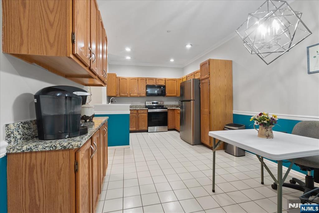 2 Richmond Road, Unit 306 West Milford, NJ 07480 - Photo 20 of 33 a kitchen with stainless steel appliances granite countertop a refrigerator a stove a sink and a microwave