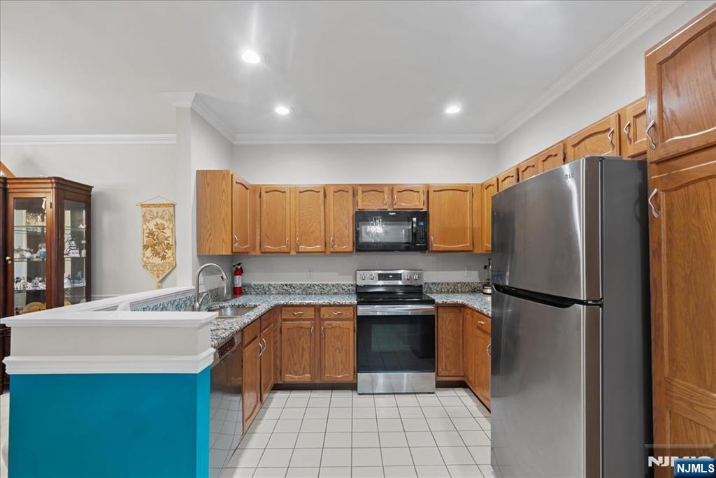 2 Richmond Road, Unit 306 West Milford, NJ 07480 - Photo 21 of 33 a kitchen with stainless steel appliances a refrigerator sink and microwave