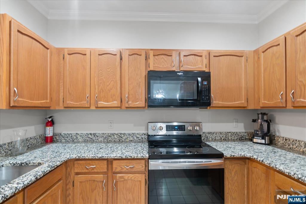 2 Richmond Road, Unit 306 West Milford, NJ 07480 - Photo 23 of 33 a kitchen with granite countertop a sink stainless steel appliances and cabinets