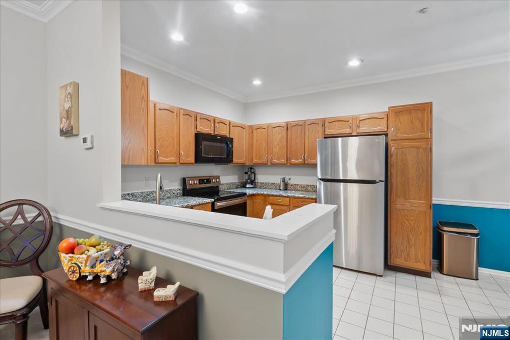 2 Richmond Road, Unit 306 West Milford, NJ 07480 - Photo 31 of 33 a kitchen with stainless steel appliances granite countertop a sink refrigerator and microwave