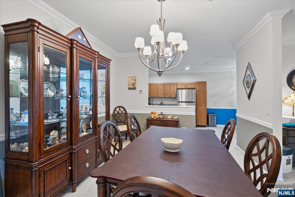 2 Richmond Road, Unit 306 West Milford, NJ 07480 - Photo 32 of 33 a view of a dining room with furniture wooden floor and chandelier