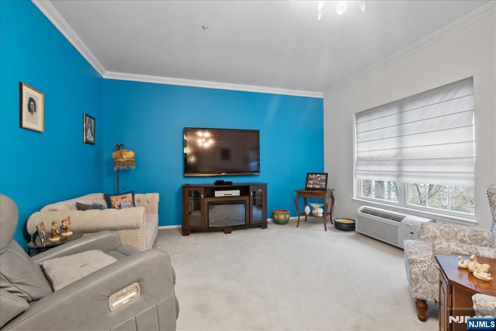 2 Richmond Road, Unit 306 West Milford, NJ 07480 - Photo 5 of 33 a living room with furniture and a flat screen tv