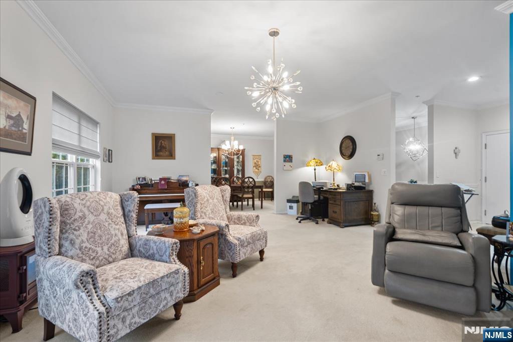 2 Richmond Road, Unit 306 West Milford, NJ 07480 - Photo 7 of 33 a living room with furniture and a chandelier