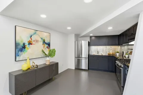 a kitchen with stainless steel appliances a refrigerator and a stove top oven