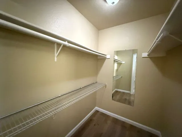 a bathroom with a granite countertop toilet a sink and a mirror