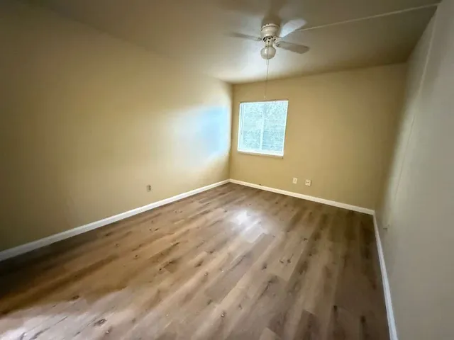 a bathroom with a granite countertop sink mirror and toilet