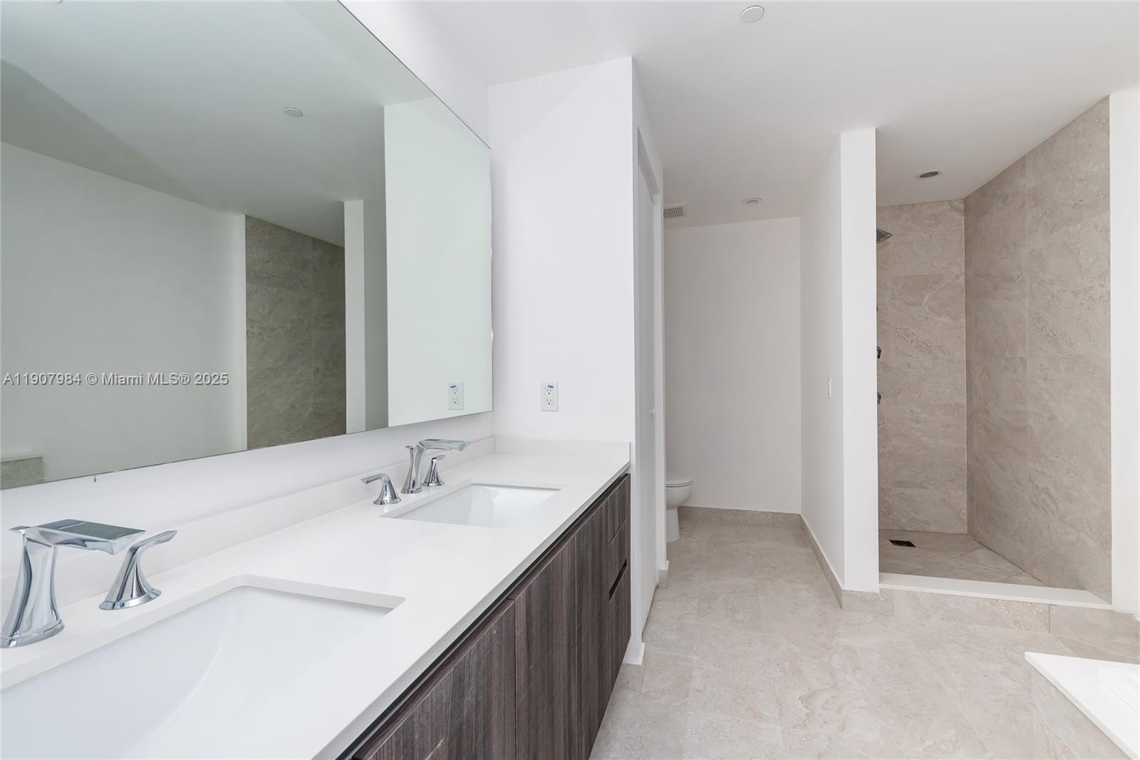 488 Northeast 18th Street, Unit 2810 Miami, FL 33132 - Photo 11 of 31 a bathroom with a sink and a mirror
