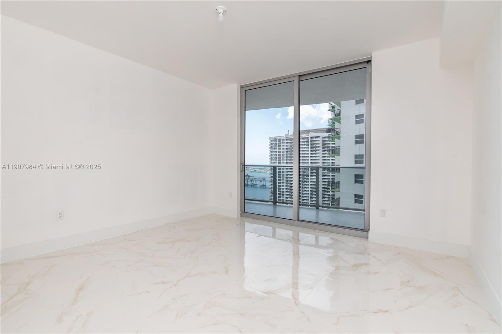 488 Northeast 18th Street, Unit 2810 Miami, FL 33132 - Photo 12 of 31 a view of a room with sliding glass door