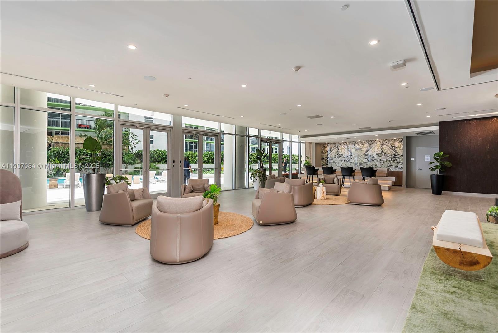 488 Northeast 18th Street, Unit 2810 Miami, FL 33132 - Photo 25 of 31 a living room with furniture and a potted plant