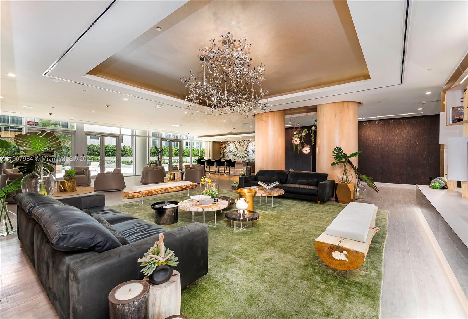 488 Northeast 18th Street, Unit 2810 Miami, FL 33132 - Photo 26 of 31 a living room with furniture and a chandelier