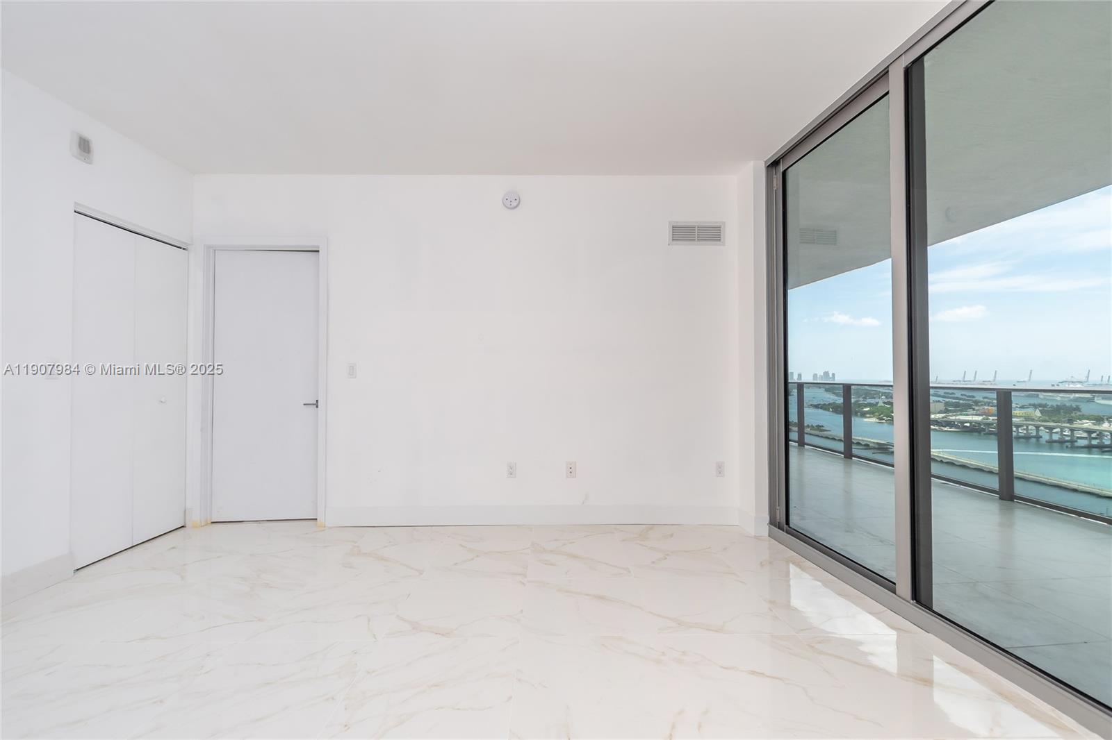488 Northeast 18th Street, Unit 2810 Miami, FL 33132 - Photo 10 of 31 an empty room with sliding glass door