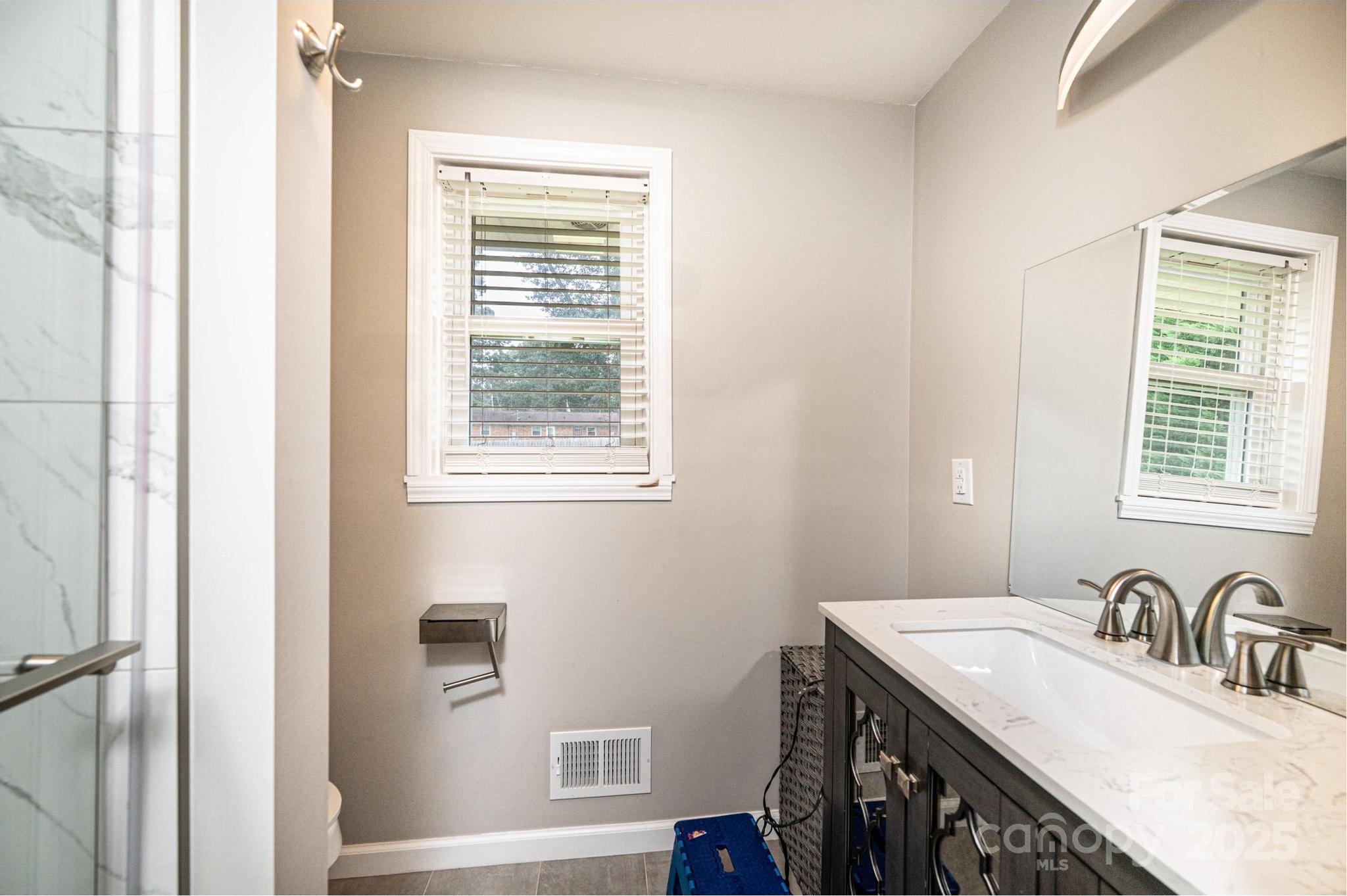 2841 21st Street Northeast Hickory, NC 28601 - Photo 16 of 43 a bathroom with a granite countertop sink and a window