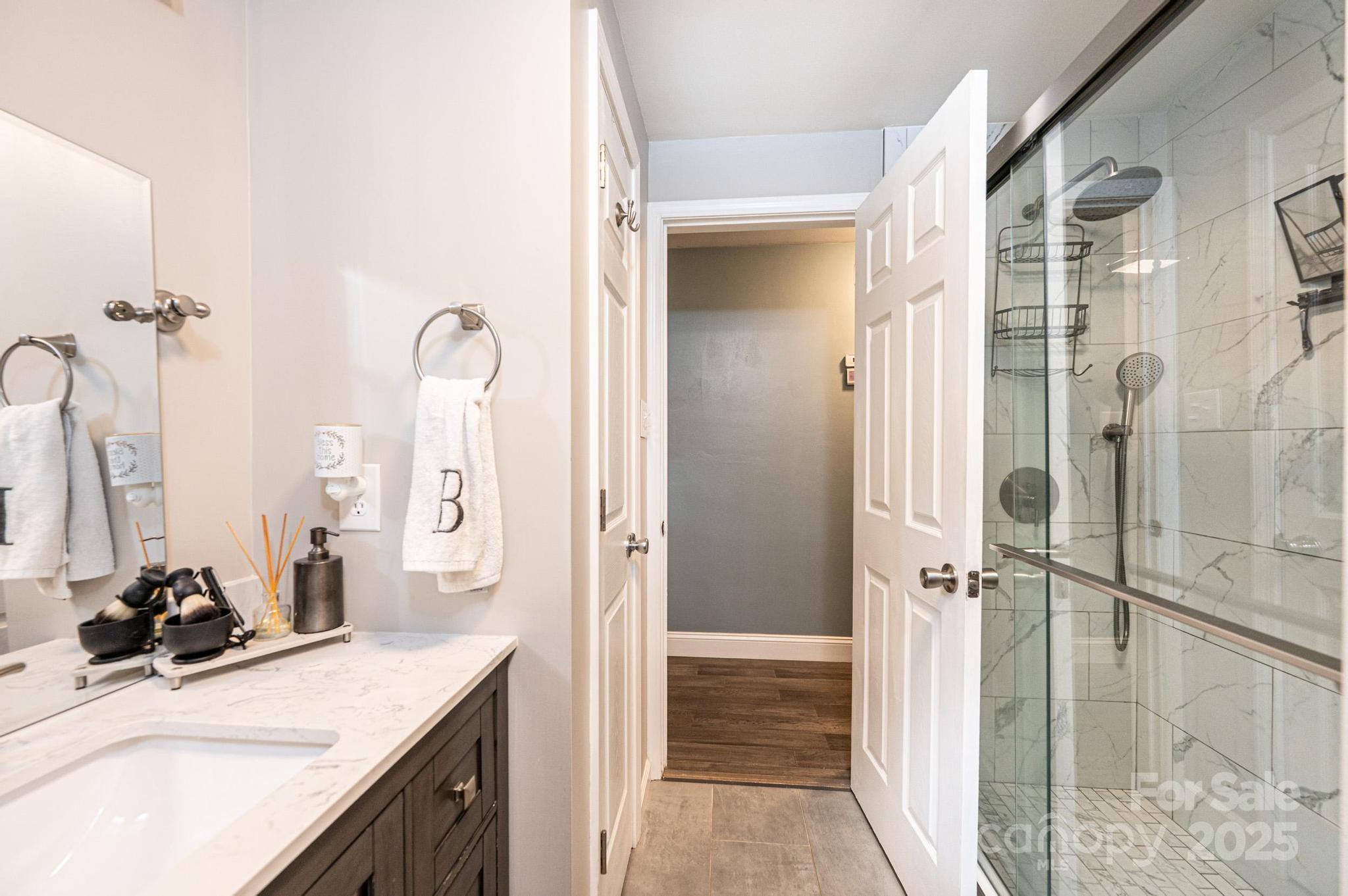 2841 21st Street Northeast Hickory, NC 28601 - Photo 17 of 43 a bathroom with a granite countertop sink a mirror and a shower