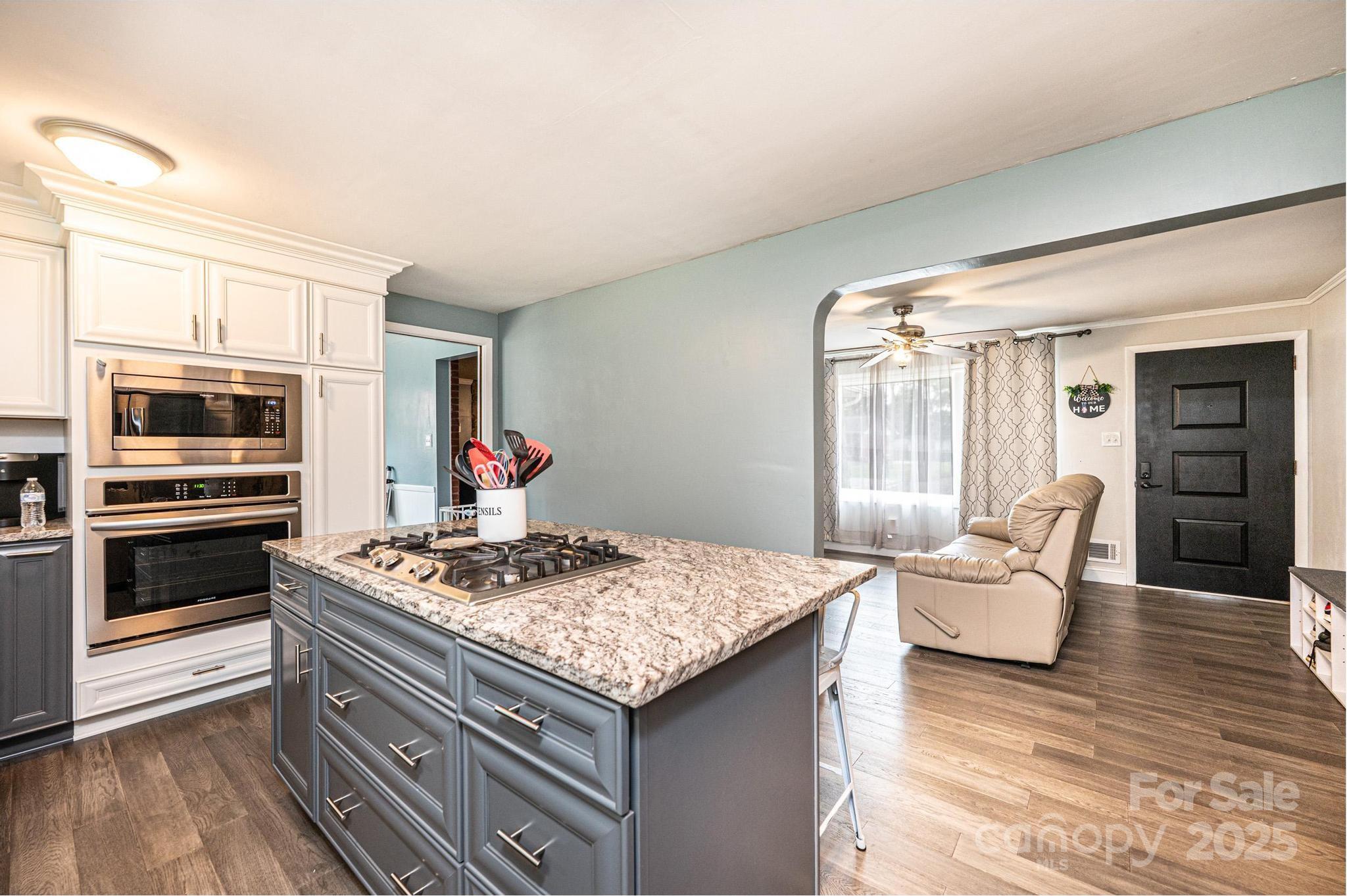 2841 21st Street Northeast Hickory, NC 28601 - Photo 8 of 43 a open kitchen with stainless steel appliances granite countertop a stove refrigerator and a living room view
