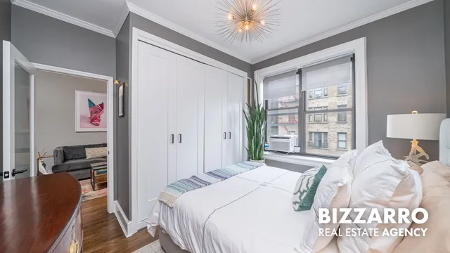 a bedroom with a bed and a potted plant