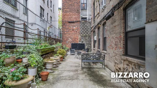 a view of a patio with plants and chairs