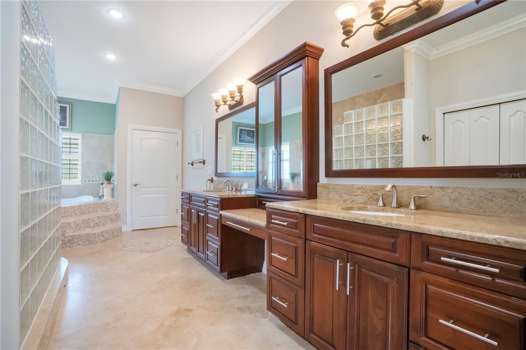 5785 Gilliam Road Orlando, FL 32818 - Photo 37 of 100 a spacious bathroom with a granite countertop sink and a mirror