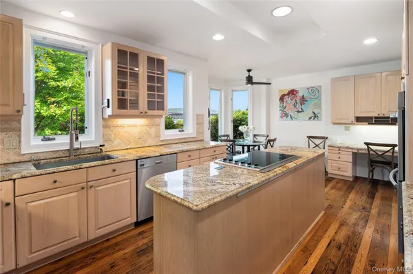a kitchen with stainless steel appliances granite countertop a sink stove and cabinets