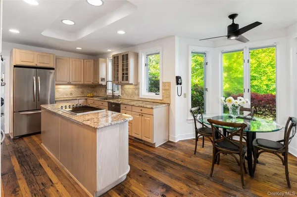 a kitchen with a stove a refrigerator and wooden floor