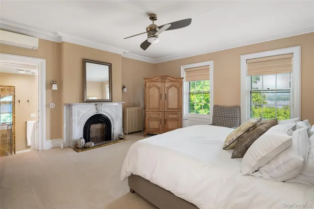 a spacious bedroom with a large bed and a chandelier